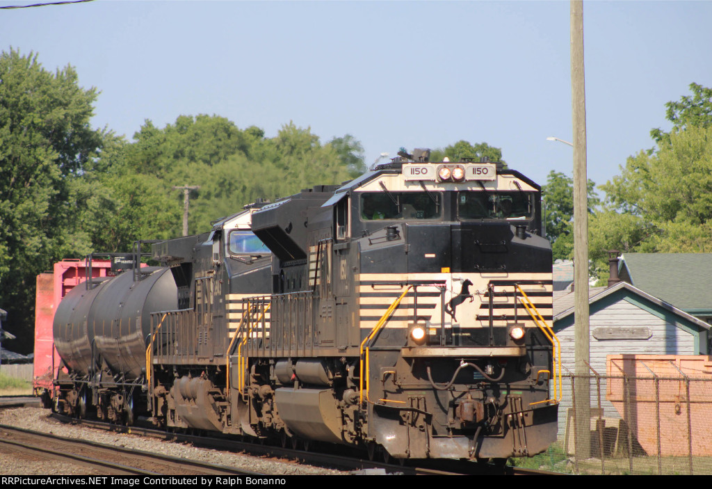 Westbound manifest about to enter the yard from the east passing the Amtrak station